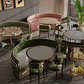 Green And Pink Banquette Sofas In Restaurant Interior With Round Tables And Chairs