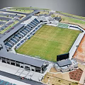 Aerial View Of Modern Football Stadium With Green Lawn Seating Stands And Parking Lots
