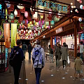 Vibrant Commercial Street With Colorful Lanterns Neon Signs Shops And Pedestrians