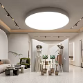 Modern Clothing Store Interior Design With Mannequins Sofa Plants And Clothing Racks