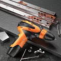Orange And Black Electric Drill With Metal Parts Screws And Nuts On Workbench