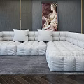 White Plush Sectional Sofa With Multiple Cushions Gray Wall Artwork And Dark Wood Flooring