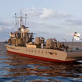 Warship Sailing On Calm Ocean Under Clear Sky With Gray Hull Red Bottom And Flags