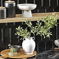 Modern Kitchen Cabinets with Black Tiled Wall Decorative Vases Green Plants Bowls and Wooden Board