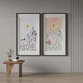 Two Framed Snowy Mountain Sun Paintings On Wall With Small Wooden Table Plant And Books