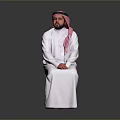 Man In Traditional White Robe With Pink Headscarf Sitting On Gray Background