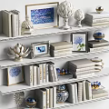 White Bookshelves With Stacked Books Magazines Framed Blue White Art And Decorative Ornaments