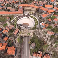 Urban Building Complex with Red Roofs and Central Circular Square in Aerial View