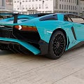 Blue Sports Car With Rear Spoiler Black Wheels And Modern Exterior Design