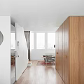 Minimalist Duplex Living Room Interior With Wooden Bookshelves And Staircase