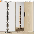 Indoor Columnar Sculptures Featuring Silver Metal And Wooden Carvings With Diamond Shaped Cylindrical Stacked Design