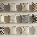 Decorative Pillows With Various Patterns In Beige Brown Black White Neutral Tones On Light Wall