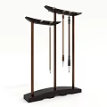 Three Elegant Calligraphy Brushes Hanging On Traditional Wooden Stands