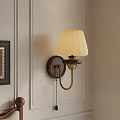 Classic Wall Lamp With White Pleated Lampshade And Metal Base On Light Colored Wall