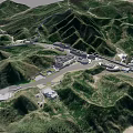 Scenic Aerial View of Green Mountain Valley With Roads and Buildings