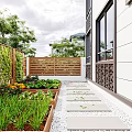 Wooden Fence Enclosed Garden Landscape With Raised Planter Boxes Vegetables Stone Path And Lawn