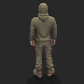 Man in Green Hoodie and Khaki Pants Standing with Brown Boots on Dark Background