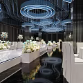 Luxurious Banquet Hall With Circular Crystal Chandeliers White Stage Floral Decor And Glossy Reflective Floor
