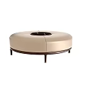 Round Beige Upholstered Ottoman Featuring Central Opening And Dark Slim Legs