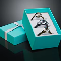 Three Elegant Rings In Open Blue Gift Box With White Ribbon And Side Box