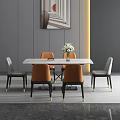 Modern Dining Table Set With White Marble Top And Orange Gray Chairs And Flower Vase