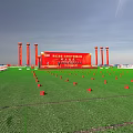 Event Venue Setup With Green Lawn Stage Red Arches And Blue Cars