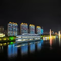 Night View of River Scenery with Illuminated High-Rise Buildings and Cruise Ship Reflecting on Water