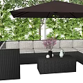 Outdoor Rattan Sectional Sofa With Brown Umbrella And Green Garden Plants