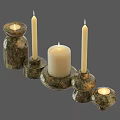 Natural Textured Stone Candle Holders With White Lit Candles And Various Designs