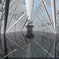 Amusement Park Indoor Attraction With Glass Dome Blue Lighting Reflective Floor And Geometric Frame Design