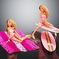 Blonde Dolls In Pink Swimwear Sitting On Pink Striped Mat And Gold Accent Surfboard