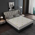 Modern Mattress With Green Leaf Patterns And Gray Upholstered Headboard In Bedroom