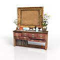 Vintage Wooden Dresser With Golden Framed Mirror And Decorative Items On Top