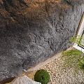 Garden Decorative Arrangement With Stone Wall Pebble Ground Stones Green Shrubs And Fern Plant
