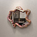 Irregular Shaped Mirror With Colorful Striped Frame Reflecting Bedroom Bed Copper Decor On Gray Wall