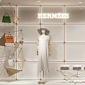 Hermes Store Window Display With Luxury Handbags White Dress And Metallic Frame Decorations