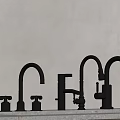 Different Styles Of Black Metal Faucets On Countertop With Wall Background