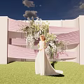 Bridal White Gown Standing By Pink White Decorative Structure With Floral Arrangement On Green Grass