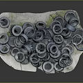 Pile of Stacked Used Tires on White Surface with Gray Background