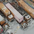 Old Abandoned Trucks Stacked In Dilapidated Ruins With Scattered Rusty Wreckage