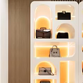 Multiple White Display Shelves with Orange Lighting and Handbag 3d model