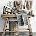 Bathroom Accessories Display On Wooden Shelf With Towels Toiletries And Wicker Basket