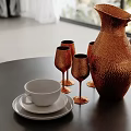 Hammered Copper Pitcher And Four Goblets With White Cup On Black Table
