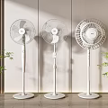 Three Modern White Standing Air Cooler Fans In Indoor Minimalist Decor With Green Plants