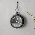 Black Round Wall Clock Hanging On Gray Wall With Green Plant Branches 3d model