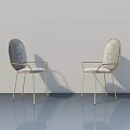 Elegant Chairs With Gold Frames And Patterned Backrests In Modern Interior Space