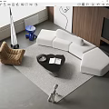 Modern White L Shaped Sofa With Black Coffee Table And Accent Chair On Rug