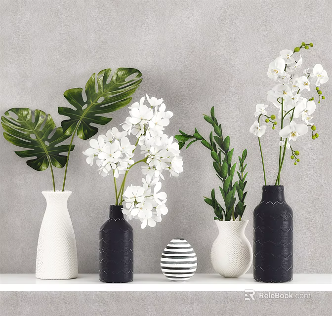 White Orchids And Tropical Leaves In Black White Striped Vases On Table 3d model 