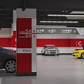 Parking Garage Interior With Red Walls Entrance Exit Signs Left Turn Arrows And Parked Cars
