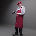Man Wearing Red Cap In White Shirt And Red Apron Holding Black Bottle